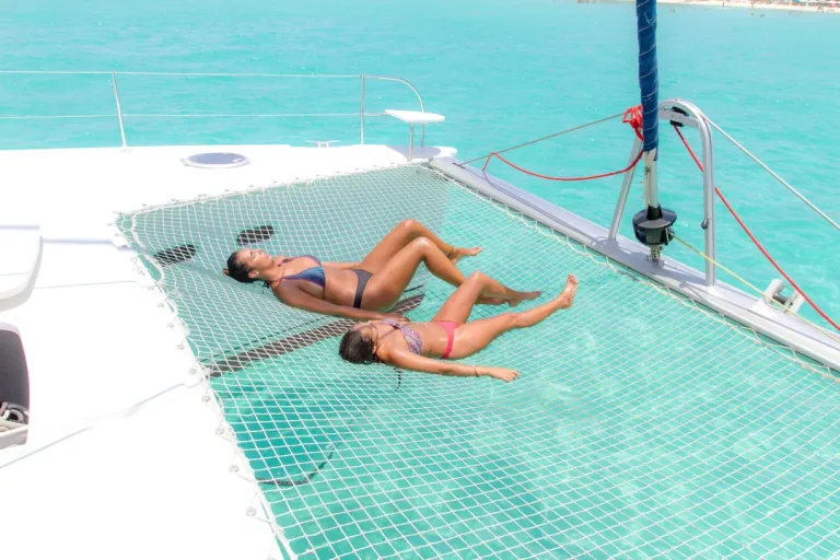 Guests relaxing on a charter catamaran underway