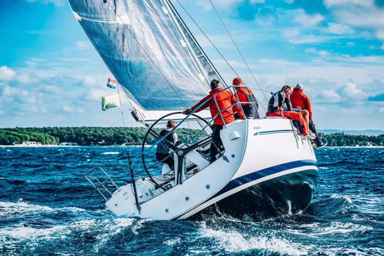 Monohull sailboat heeling over at an angle while sailing upwind